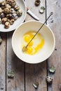 Broken quail eggs in a bowl Royalty Free Stock Photo