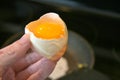 Cracked Fresh Egg over a Pan in a Kitchen Reastaurant, fresh, farmhouse, homesteading, natural chicken egg. Farming Country Life Royalty Free Stock Photo