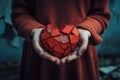 Broken red heart figure in girls hands. Betrayal.