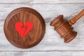 Broken red heart and gavel.