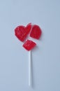 A broken red heart lollipop symbolizing a broken heart