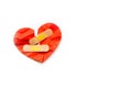 Broken red heart symbol with medical patch on white background, love concept. healing Royalty Free Stock Photo