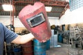 Broken Red welding mask in the man hand