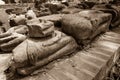 The broken remains of an ancient 20th-century Buddha statue in vintage tone