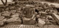 The broken remains of an ancient 20th-century Buddha statue in vintage tone