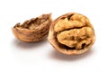 Broken ripe walnut with full kernel and shell, close up macro, isolated on a white background. Royalty Free Stock Photo