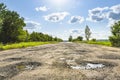 Broken road, potholes and pits Royalty Free Stock Photo