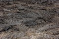 A broken rural country road after the rain. Puddles after rain on a dirt road. Clay, soil and puddles at cloudy day Royalty Free Stock Photo