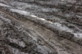 A broken rural country road after the rain. Puddles after rain on a dirt road. Clay, soil and puddles at cloudy day Royalty Free Stock Photo