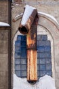 Broken rusty pipe in the red brick wall of abandoned old factory building Royalty Free Stock Photo