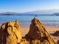 Broken sand castles - calm beach in the background