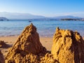 Broken sand castles on a empty sand beach
