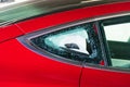 Broken and shattered red car read window