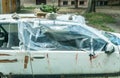 Broken and shattered window glass on the damaged car doors covered with plastic nylon close up after crash accident Royalty Free Stock Photo