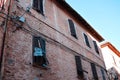 A broken shutter of a window in a brick building Corinaldo, Marche Royalty Free Stock Photo