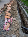 Broken sidewalk. Conducting the cable underground. Cable laying work. Communications in the city. Electrification Royalty Free Stock Photo