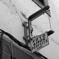 A broken sign above an abandoned and derelict photography shop in madeira portugal the sign reads in english, picture perfect love