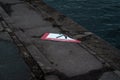 Broken sign on the embankment in the spring