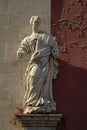 Broken statue of an apostle without arms