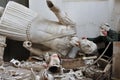 Broken statue and man with plaster mask fragment