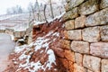 Broken Stone wall in vineyard water and snow damage. Royalty Free Stock Photo