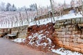 Broken Stone wall in vineyard water and snow damage. Royalty Free Stock Photo