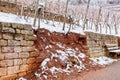 Broken Stone wall in vineyard water and snow damage. Royalty Free Stock Photo