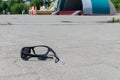 Broken sunglasses lie on a stone-tiled walkway in the city Park