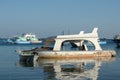 Broken sunken pleasure boat in the water,