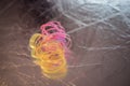 Broken, tangled plastic spring toy lies on dark background with bokeh Royalty Free Stock Photo