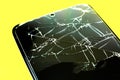 Broken tempered glass screen protector. Crashed smartphone. Close up