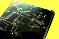Broken tempered glass screen protector. Crashed smartphone. Close up