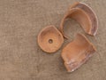 A broken terracotta flowerpot on hessian, top view, frost damage.