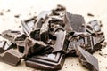 Broken to pieces dark chocolate, crushed and powder pieces. Royalty Free Stock Photo
