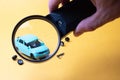 Broken toy car under magnifying glass Royalty Free Stock Photo