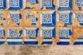 Broken traditional blue tiles on faÃ§ade of a building of famous Alfama district in Lisbon