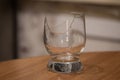 Broken transparent drinking glass on the table