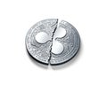 Broken into two pieces silver Ripple coin XRP isolated on white background.