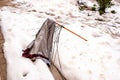 Broken umbrella abandoned on the snowy street by a storm of wind, rain and snow Royalty Free Stock Photo