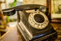 Broken vintage black phone on old wooden table background Royalty Free Stock Photo