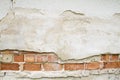 Broken vintage bricklaying wall fragment from old red clay bricks and plaster frame background texture Royalty Free Stock Photo