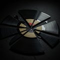 A broken vinyl record shattered into several wedge-shaped pieces on a dark surface. Royalty Free Stock Photo