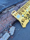 Broken Wall in A Carpark Been Hit by a Car With Warning Barrier Around the Fallen Bricks Royalty Free Stock Photo