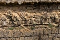 Broken wall of an old house nearby, traces of climate weathering. Cracked wall texture with hole. Brick stone wall of building Royalty Free Stock Photo