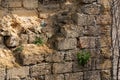 Broken wall of an old house nearby, traces of climate weathering. Cracked wall texture with hole. Brick stone wall of building Royalty Free Stock Photo