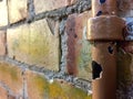 Broken water pipe on a brick wall Royalty Free Stock Photo
