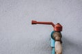 Broken water tap beside white old concrete wall Royalty Free Stock Photo