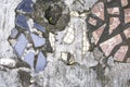 Broken white, blue and red tile pieces in concrete pavement texture Royalty Free Stock Photo