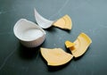 Broken white and yellow pottery scattered on black kitchen floor Royalty Free Stock Photo