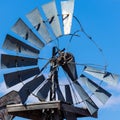 Broken windmill against a blue sky